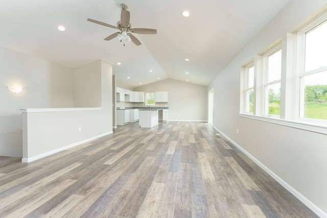 9674 Iosco Ridge Dr, Gregory, MI 48137 - unfurnished living room featuring vaulted ceiling, light wood-style floors, ceiling fan, recessed lighting, and baseboards