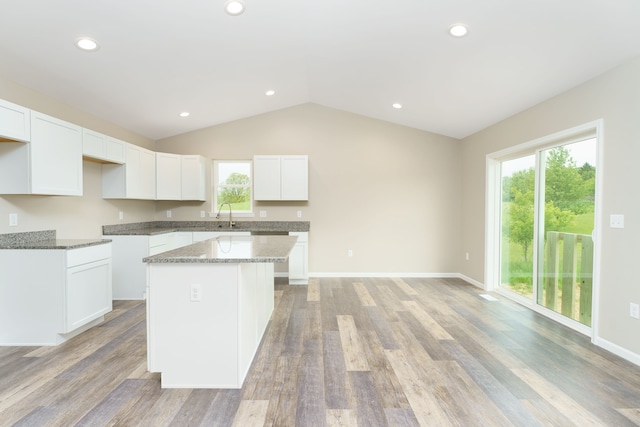 9674 Iosco Ridge Dr, Gregory, MI 48137 - kitchen with a kitchen island, plenty of natural light, a sink, white cabinets, and vaulted ceiling