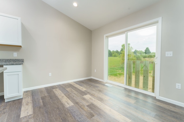 9674 Iosco Ridge Dr, Gregory, MI 48137 - unfurnished dining area with wood finished floors, baseboards, vaulted ceiling, and recessed lighting