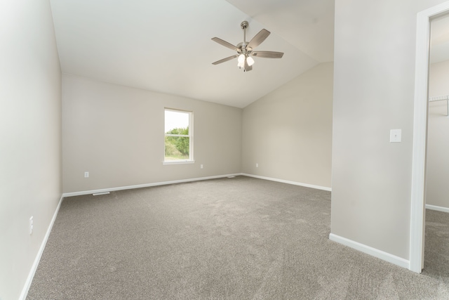 9674 Iosco Ridge Dr, Gregory, MI 48137 - carpeted empty room with a ceiling fan, vaulted ceiling, and baseboards