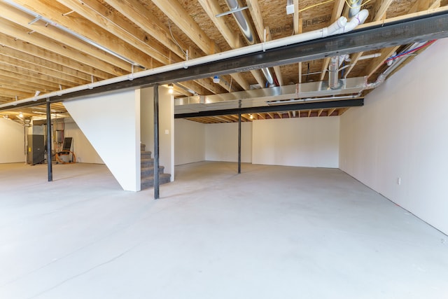 9674 Iosco Ridge Dr, Gregory, MI 48137 - unfinished basement featuring stairway and heating unit