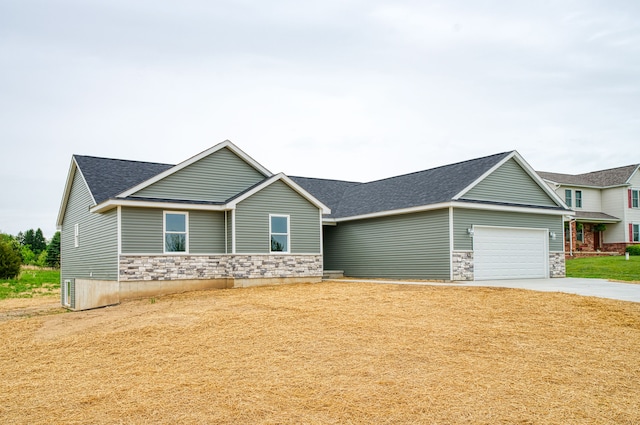 9674 Iosco Ridge Dr, Gregory, MI 48137 - view of front of home featuring stone siding, an attached garage, concrete driveway, and roof with shingles