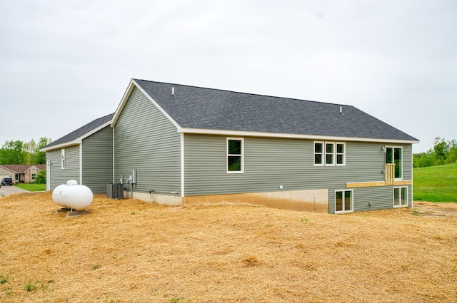 9674 Iosco Ridge Dr, Gregory, MI 48137 - view of property exterior featuring central AC and a shingled roof