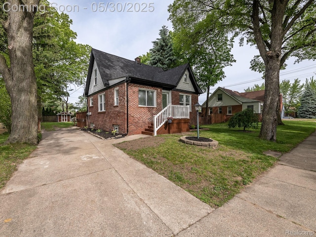 3914 Grindley Park St, Dearborn Heights, MI 48125 - view of front of property with brick siding, a front yard, driveway, and roof with shingles