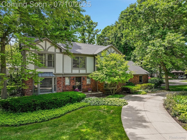 3445 Medford Dr, Troy, MI 48084 - tudor home with stucco siding, brick siding, and a shingled roof