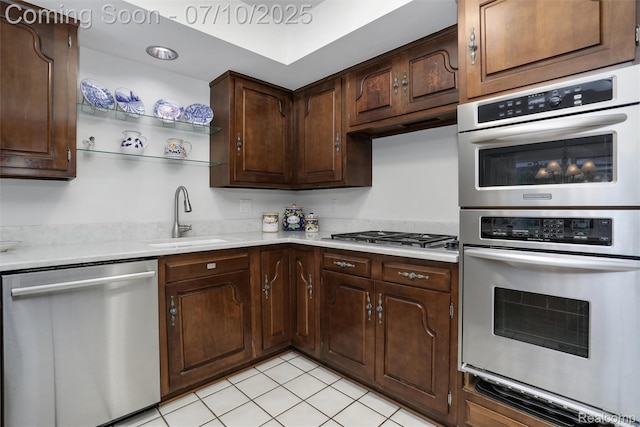 3445 Medford Dr, Troy, MI 48084 - kitchen featuring appliances with stainless steel finishes, light countertops, light tile patterned flooring, and dark brown cabinets