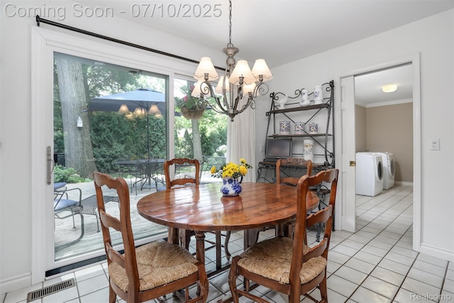 3445 Medford Dr, Troy, MI 48084 - dining area featuring washing machine and clothes dryer, a chandelier, light tile patterned floors, and ornamental molding