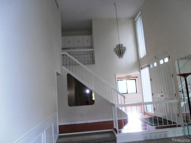 5086 Falmouth Dr, Troy, MI 48085 - stairway featuring a towering ceiling