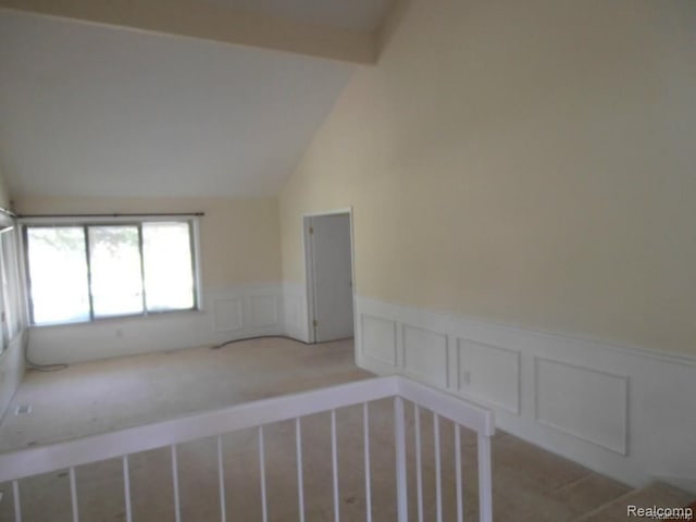 5086 Falmouth Dr, Troy, MI 48085 - unfurnished room with a decorative wall, wainscoting, light colored carpet, and lofted ceiling