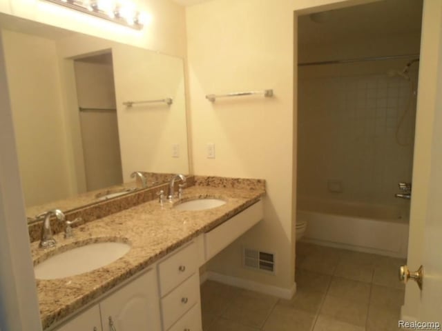 5086 Falmouth Dr, Troy, MI 48085 - full bathroom with tile patterned floors, toilet, double vanity, and baseboards