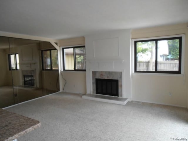 5086 Falmouth Dr, Troy, MI 48085 - unfurnished living room with a fireplace, healthy amount of natural light, and carpet flooring