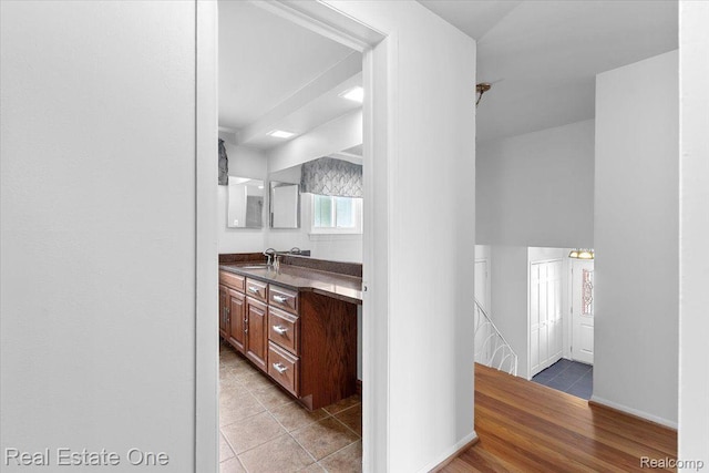 16917 Cicotte Ave, Allen Park, MI 48101 - bar area featuring a sink, baseboards, and light tile patterned floors