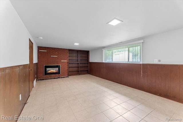 16917 Cicotte Ave, Allen Park, MI 48101 - unfurnished living room with wooden walls, wainscoting, built in shelves, a fireplace, and light tile patterned flooring