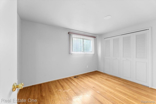 16917 Cicotte Ave, Allen Park, MI 48101 - unfurnished bedroom featuring wood finished floors, a closet, and baseboards