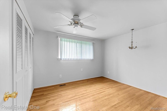 16917 Cicotte Ave, Allen Park, MI 48101 - unfurnished bedroom featuring a closet, light wood-style floors, a chandelier, a ceiling fan, and baseboards