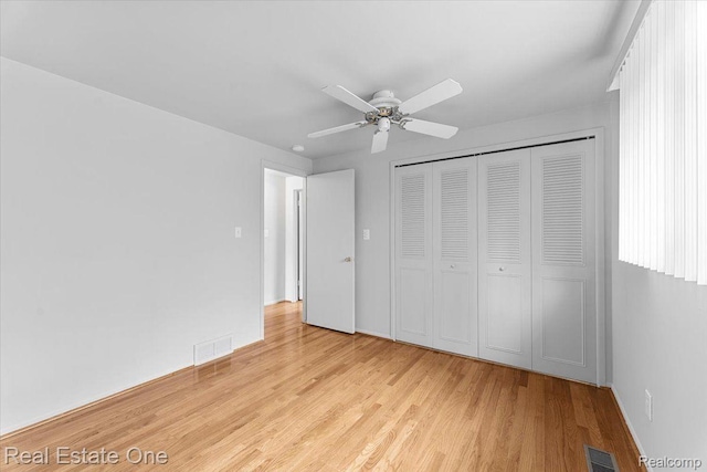 16917 Cicotte Ave, Allen Park, MI 48101 - unfurnished bedroom featuring light wood finished floors, a closet, a ceiling fan, and baseboards