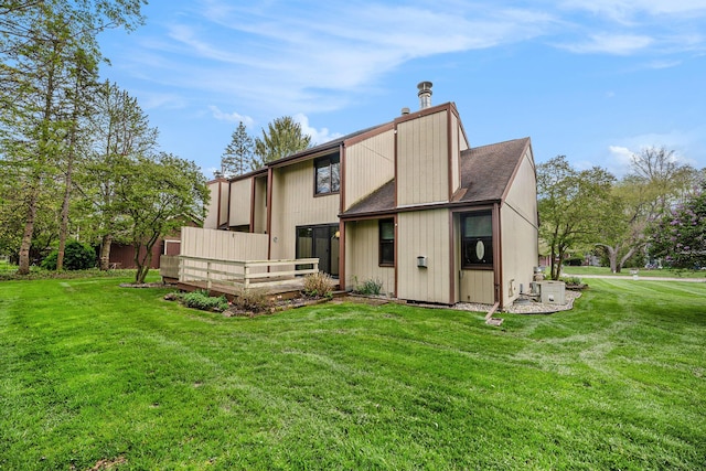 2373 Fairgrove St, Kalamazoo, MI 49009 - back of property featuring a yard, a wooden deck, and roof with shingles