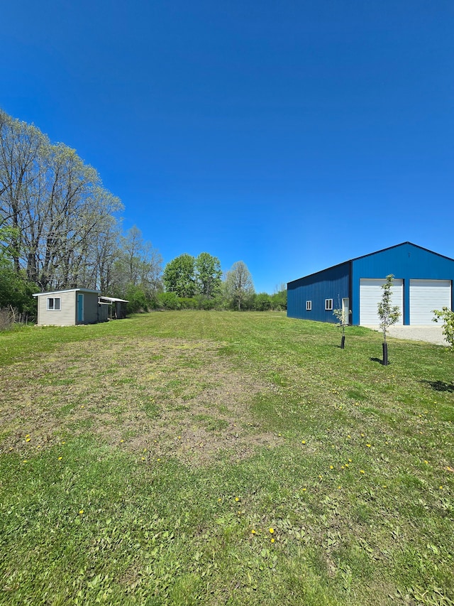 20223 32 Mile Rd, Armada, MI 48005 - view of green lawn featuring an outdoor structure, a garage, and a pole building