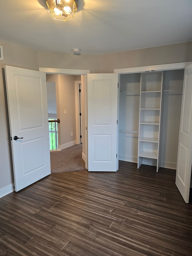 20223 32 Mile Rd, Armada, MI 48005 - unfurnished bedroom featuring a closet, baseboards, and dark wood finished floors