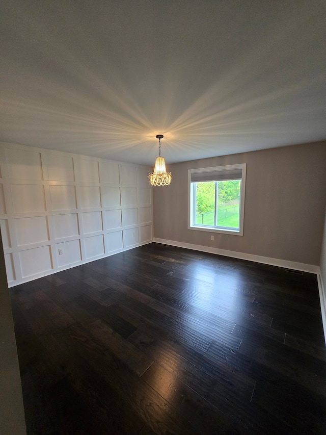 20223 32 Mile Rd, Armada, MI 48005 - empty room with a chandelier, dark wood-style flooring, and baseboards