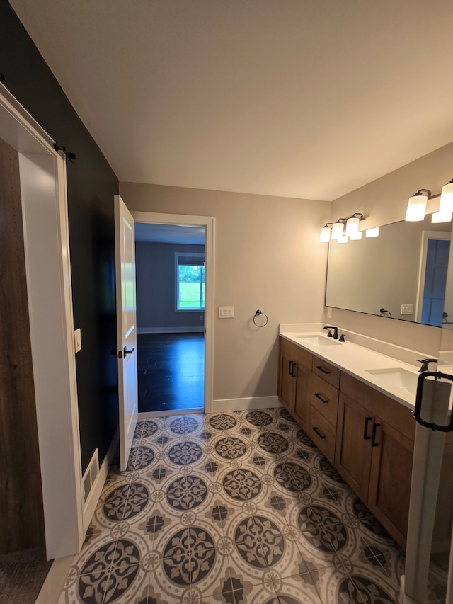 20223 32 Mile Rd, Armada, MI 48005 - bathroom featuring baseboards, double vanity, and tile patterned flooring