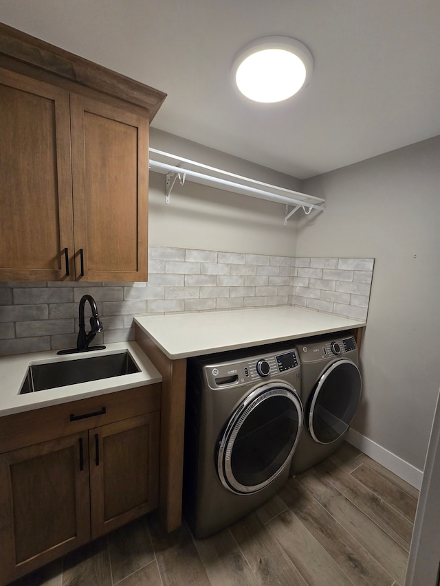 20223 32 Mile Rd, Armada, MI 48005 - washroom featuring washer and dryer, cabinet space, wood finished floors, and baseboards