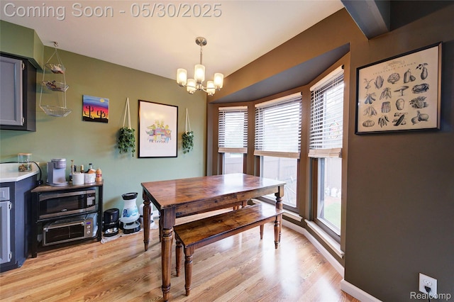 41381 Northwind Dr, Canton, MI 48188 - dining space featuring a chandelier, healthy amount of natural light, and light wood-style flooring