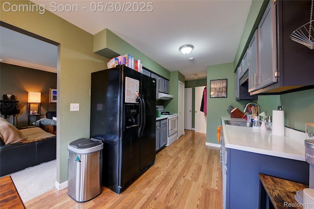 41381 Northwind Dr, Canton, MI 48188 - kitchen with electric range, a sink, black fridge, light wood-style floors, and light countertops