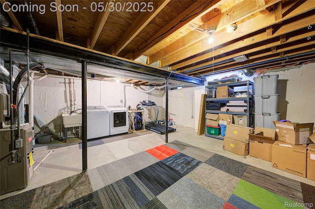 41381 Northwind Dr, Canton, MI 48188 - unfinished basement featuring washer and dryer, a sink, and heating unit
