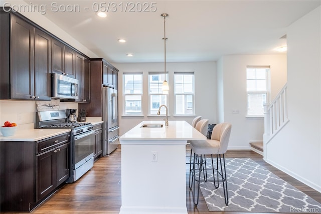3217 Chambers W Unit 87, Wixom, MI 48393 - kitchen featuring stainless steel appliances, a sink, a kitchen bar, dark brown cabinets, and recessed lighting