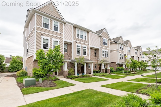 3217 Chambers W Unit 87, Wixom, MI 48393 - view of property featuring a residential view, brick siding, and a front yard