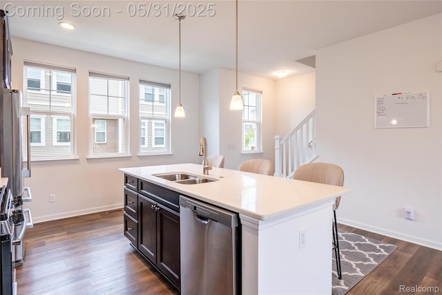 3217 Chambers W Unit 87, Wixom, MI 48393 - kitchen featuring stainless steel appliances, a sink, a breakfast bar area, dark wood-style floors, and hanging light fixtures