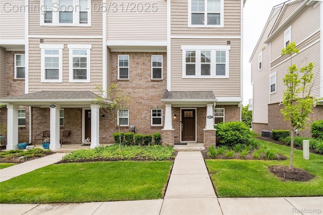 3217 Chambers W Unit 87, Wixom, MI 48393 - view of front of house with a front yard, central AC unit, and brick siding
