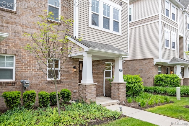 3217 Chambers W Unit 87, Wixom, MI 48393 - view of exterior entry with a porch and brick siding
