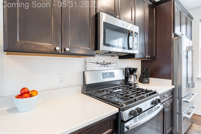 3217 Chambers W Unit 87, Wixom, MI 48393 - kitchen with appliances with stainless steel finishes, dark brown cabinetry, and light countertops
