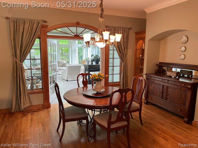 8241 Fountain View Dr, Flushing, MI 48433 - dining area featuring wood finished floors, a chandelier, and crown molding
