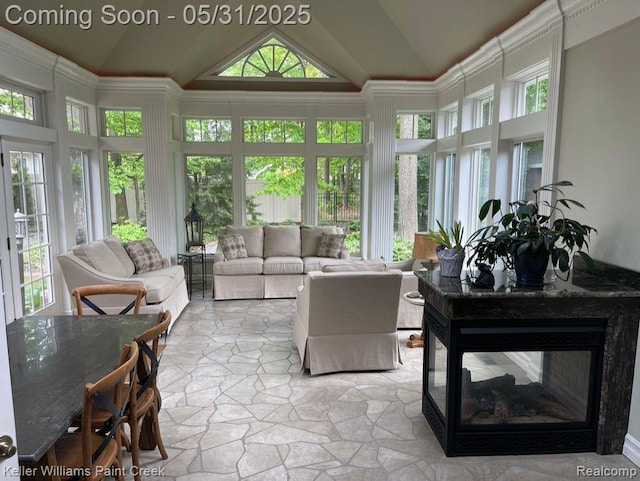 8241 Fountain View Dr, Flushing, MI 48433 - sunroom / solarium with healthy amount of natural light, stone finish flooring, and high vaulted ceiling