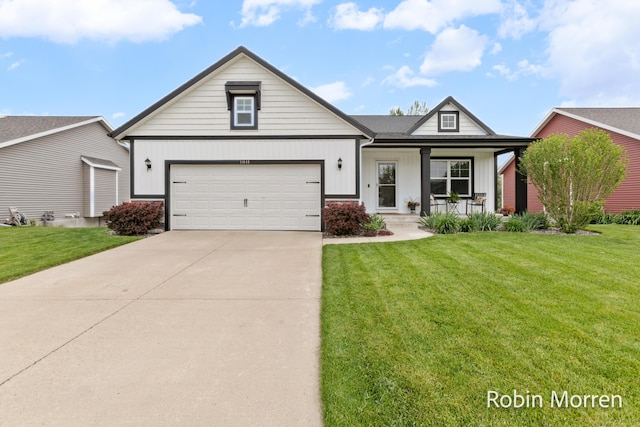 11648 Everette Ave, Allendale, MI 49401 - view of front of home featuring board and batten siding, an attached garage, concrete driveway, a front lawn, and covered porch