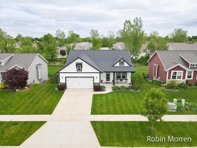 11648 Everette Ave, Allendale, MI 49401 - modern farmhouse featuring covered porch, driveway, a front lawn, and a garage