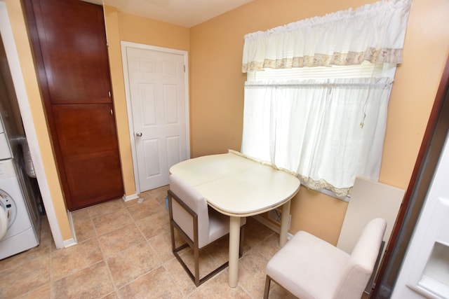 3215 Mackin Rd, Flint, MI 48504 - dining area featuring stacked washing machine and dryer and baseboards