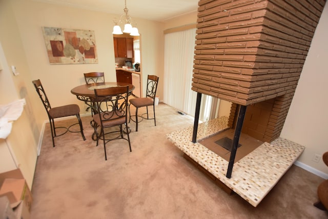 3215 Mackin Rd, Flint, MI 48504 - dining room featuring a multi sided fireplace, light colored carpet, a chandelier, and baseboards