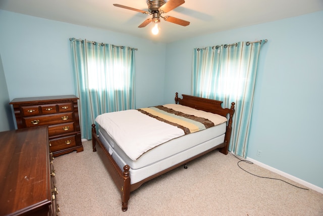 3215 Mackin Rd, Flint, MI 48504 - bedroom featuring light colored carpet, a ceiling fan, and baseboards