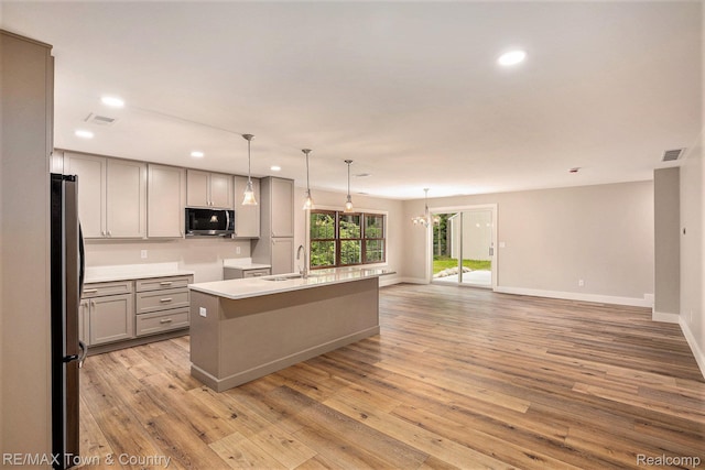 6400 N Seymour Rd, Flushing, MI 48433 - kitchen featuring appliances with stainless steel finishes, gray cabinetry, a sink, recessed lighting, and light wood finished floors