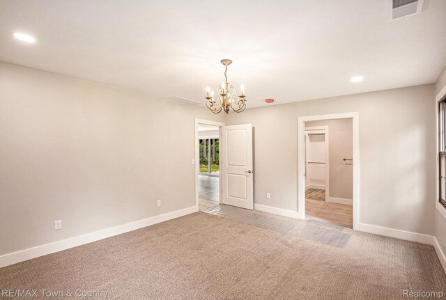 6400 N Seymour Rd, Flushing, MI 48433 - spare room featuring carpet, a chandelier, baseboards, and recessed lighting