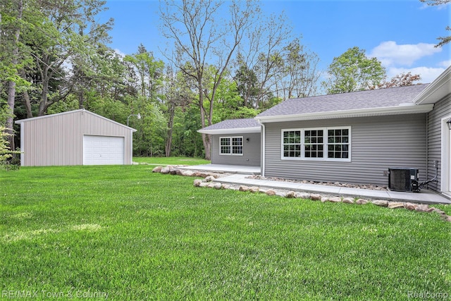 6400 N Seymour Rd, Flushing, MI 48433 - view of green lawn featuring a garage, an outdoor structure, and central AC