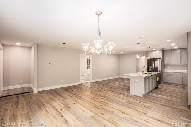 6400 N Seymour Rd, Flushing, MI 48433 - kitchen with gray cabinetry, light countertops, light wood finished floors, recessed lighting, and open floor plan