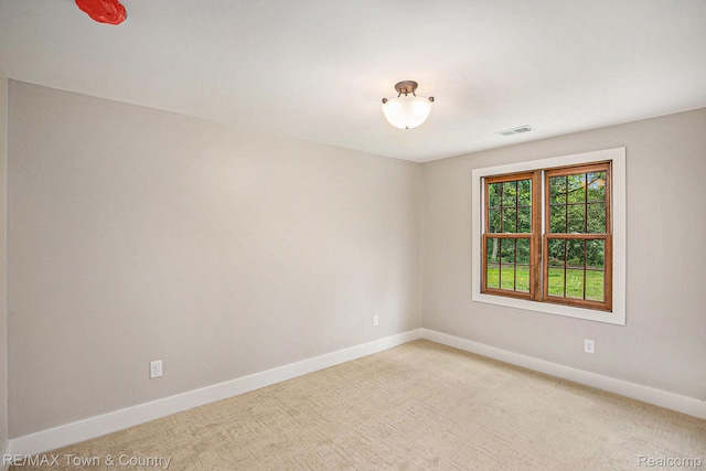 6400 N Seymour Rd, Flushing, MI 48433 - spare room featuring baseboards and light colored carpet