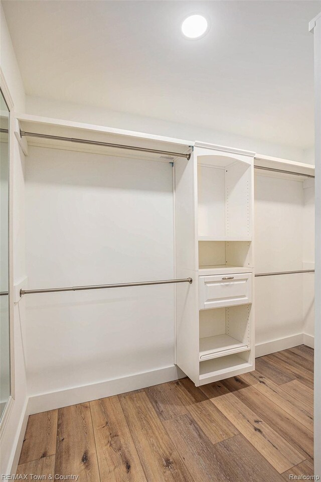6400 N Seymour Rd, Flushing, MI 48433 - walk in closet featuring wood finished floors
