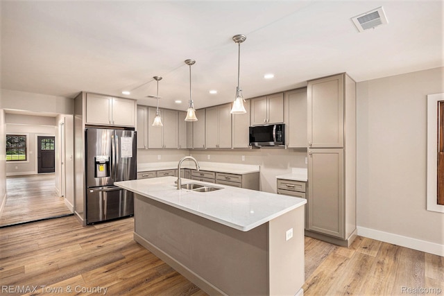 6400 N Seymour Rd, Flushing, MI 48433 - kitchen featuring stainless steel appliances, a sink, gray cabinetry, light wood finished floors, and baseboards