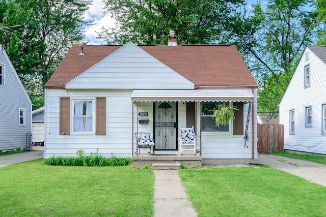 24690 Annapolis St, Dearborn Heights, MI 48125 - bungalow with covered porch, a chimney, and roof with shingles